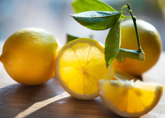 Lemons on a wooden cutting board.