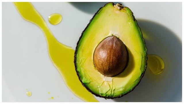 avocado surrounded by cooking oil on a tabletop