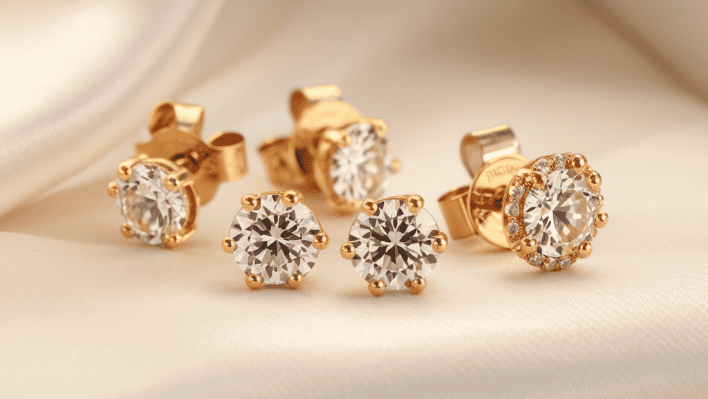 A gorgeous minimal earring stud set as a Stocking Stuffer for Women. The earrings are small, round, and made of gold with a few small diamonds. They are placed on a white background. The lighting is soft.